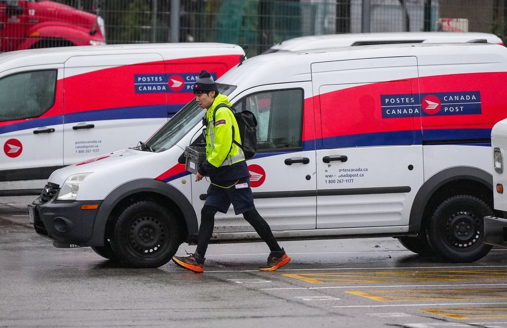 A Canada Post employee returns to a delivery depot in Vancouver, B.C., Tuesday, Dec. 17, 2024.