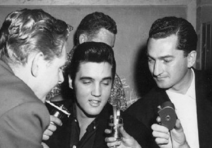 Elvis Presley (centre) speaks backstage in Vancouver on Aug. 31, 1957.